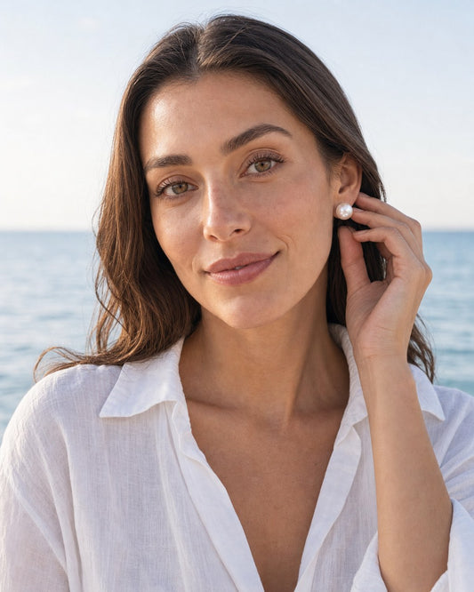 Classic pearl studs worn by the model