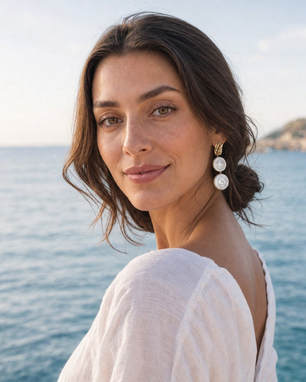 Spiral Shell Pearl Earrings worn by the model