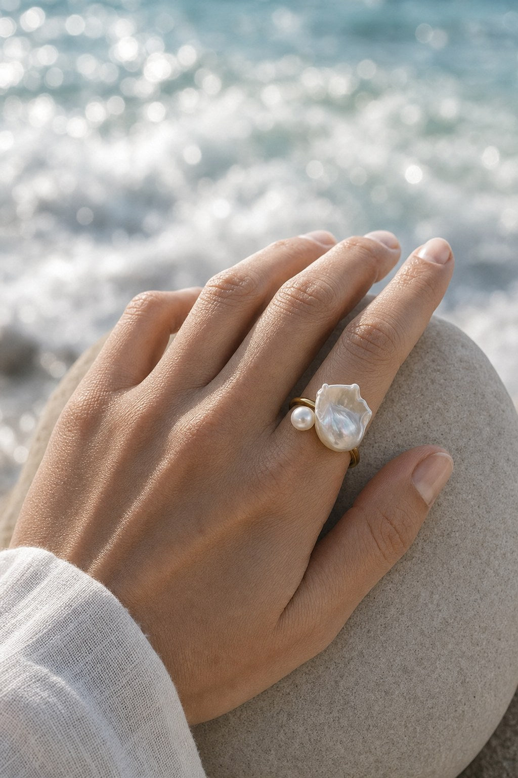 Open Shell Double Pearl Ring worn on the finger, close-up