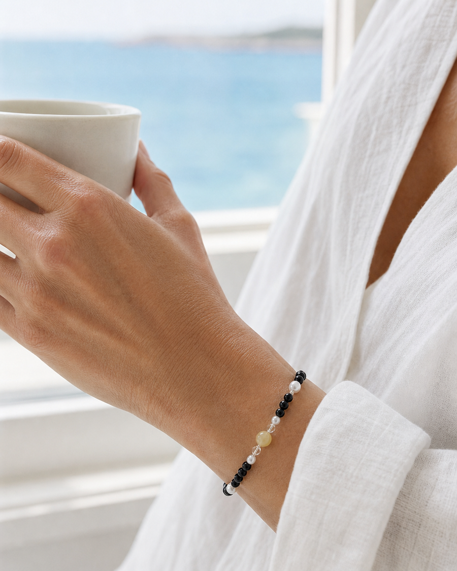 Onyx, jade and pearl bracelet on a woman's wrist