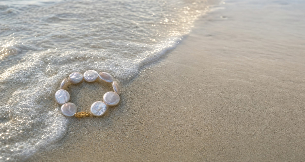 Tide Coin Pearl Bracelet at the edge of a wave